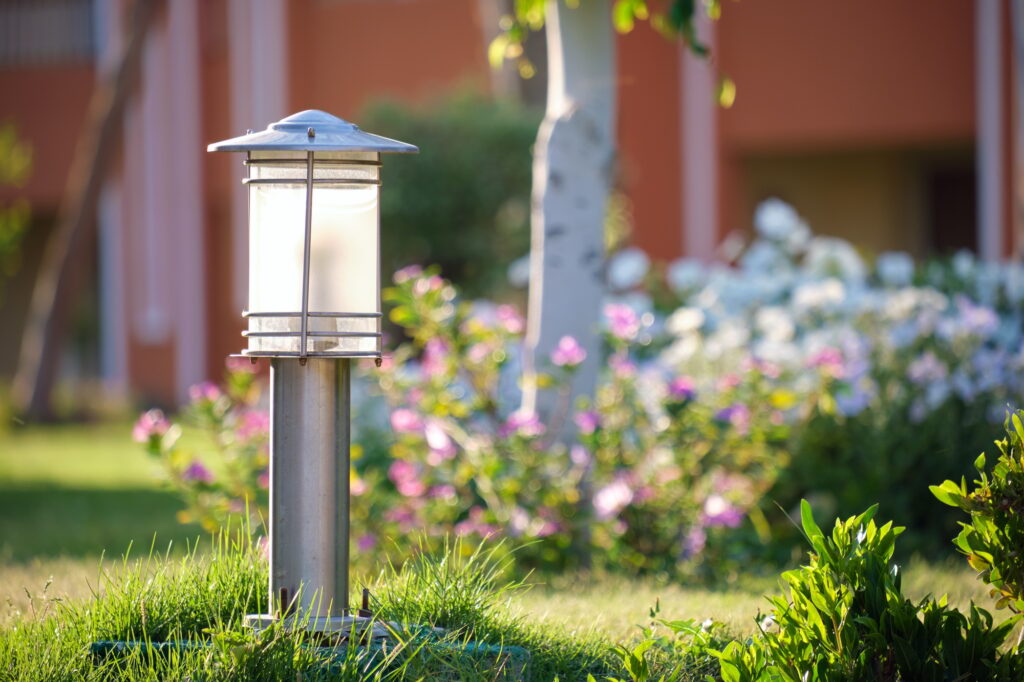 Outdoor lamp on yard lawn for garden lighting in summer park